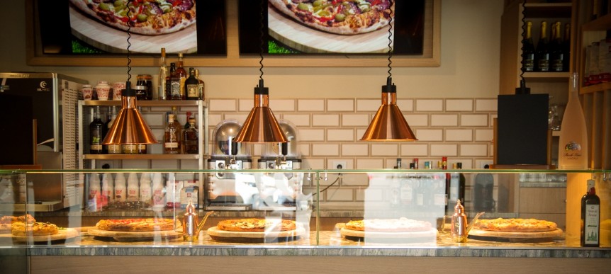 Balcao de atendimento com vitrina de exposicao, candeeiros industriais suspensos em cobre e revestimento em madeira